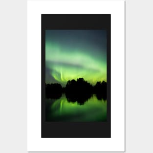 Northern lights glowing over lake in Finland Posters and Art